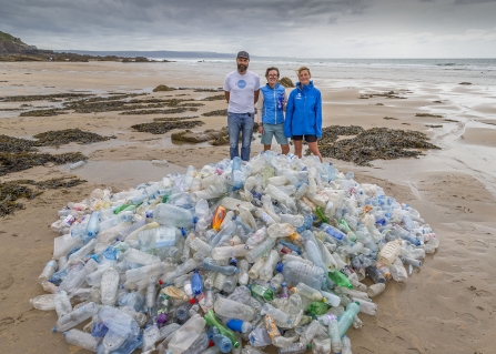 Bottle mountain on Cornish beach with ReFILL Cornwall team behind, photo by Symages