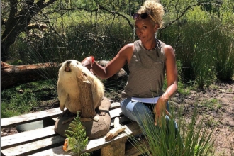 Gillian Burke poses next to Trevor the Beaver (stuffed) at Woodland Valley Farm