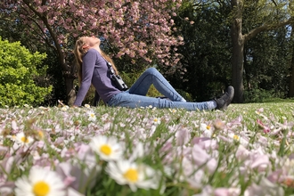 Woman sitting in a park. Image by Tom Hibbert