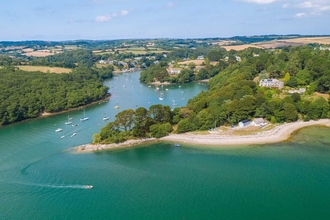 A sunny aerial shot of Pedn Billy garden and the Helford River.