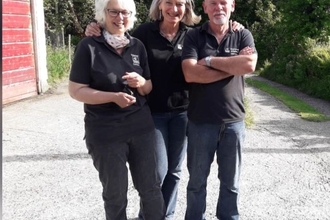 A group of three Open Gardens volunteers, smiling