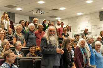 People standing up at a climate hustings