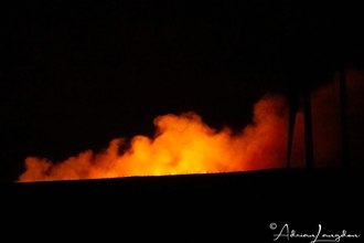 Image a wild fire blazing at night