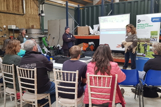 People sit and listen to a talk at a Wildlife Groundswell conference