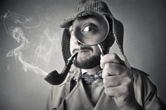 Black and white image of a detective, holding up a magnifying glass over one eye