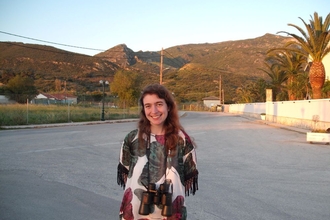 Image of a person smiling with mountains in the background