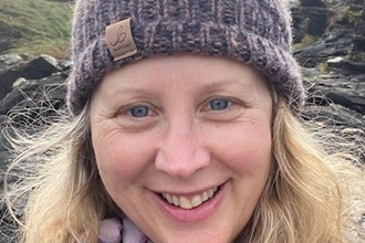 Image of a person smiling outdoors