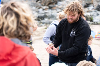Man showing people a crab