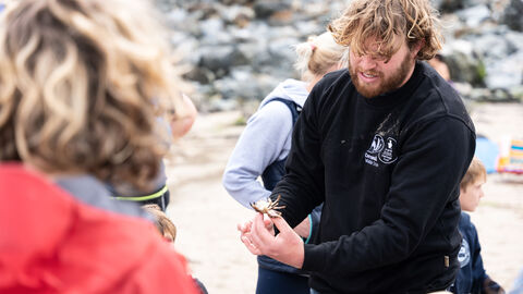 Person showing a crab at event