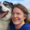 Bex Allen smiles at the camera with her dog in close contact