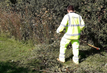 Not a mower in sight, Cormac worker trying out scything. Photo by Stuart Coleman