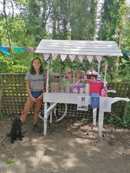 Izzy, 13, stands proudly by her sweet stall on the bissoe trail