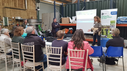 People sit and listen to a talk at a Wildlife Groundswell conference