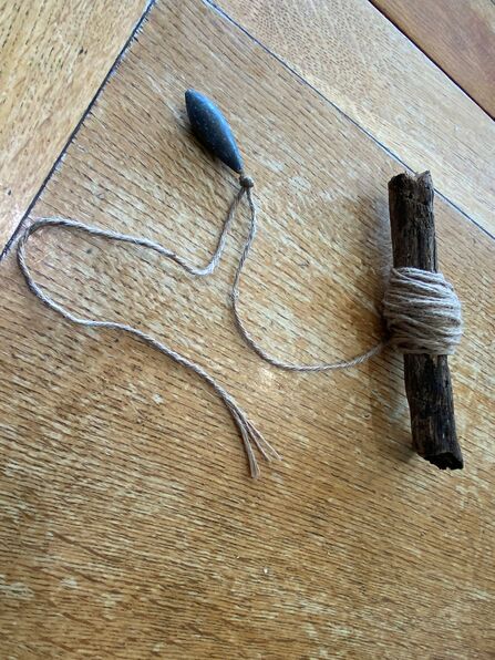 Image shows a crabbing line made from a piece of driftwood, garden twine and a fishing weight