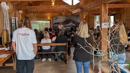 An audience gathered round to watch a presentation about Tor to Shore